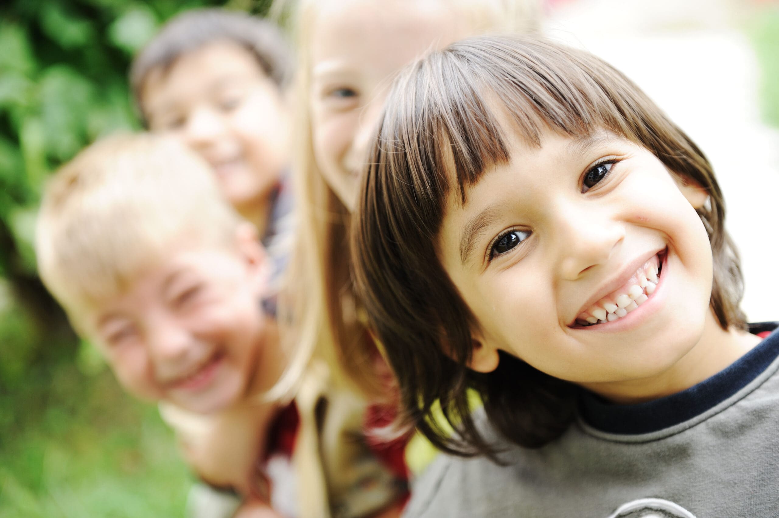 A group of children are smiling despite trauma.